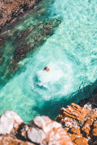 High angle view of people swimming in sea