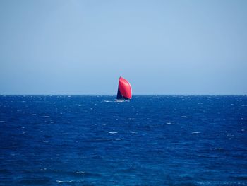 Scenic view of blue sea against clear sky