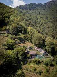 High angle view of trees and houses by mountains