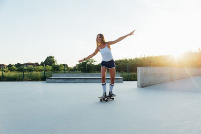 Full length of woman on skateboarding in park