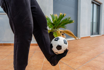Low section of man playing with soccer ball