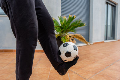 Low section of man playing soccer ball