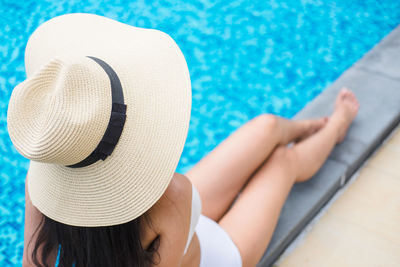 High angle view of woman wearing hat by swimming pool