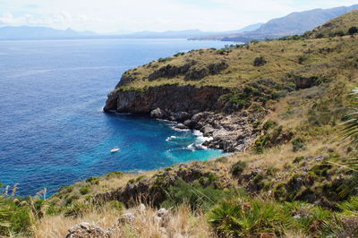 Scenic view of sea and mountains against sky