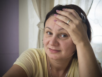 Close-up portrait of mature woman at home