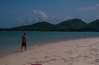 Full length of man on beach against sky