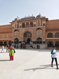 Group of people walking in front of building