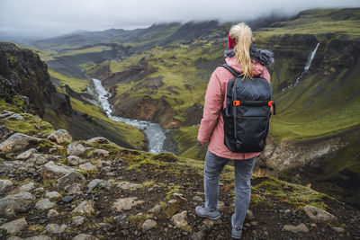 Rear view of woman standing on mountain