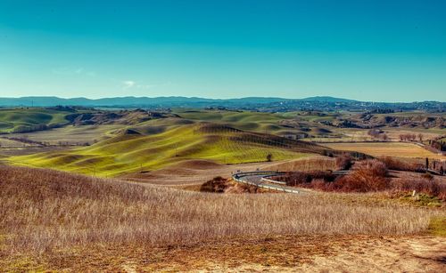 Scenic view of landscape against blue sky