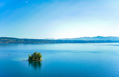 Scenic view of sea against clear blue sky