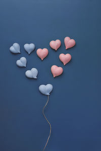 High angle view of heart shape against blue background