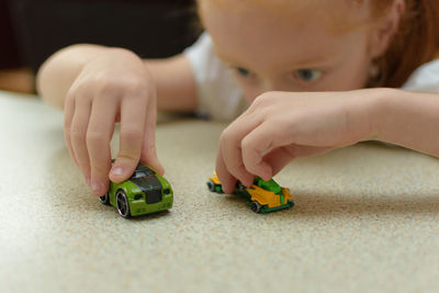 Close-up of baby playing with toy car at home