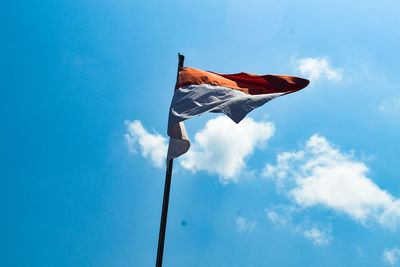 Low angle view of flag against cloudy sky