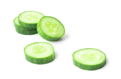 Close-up of green fruit against white background