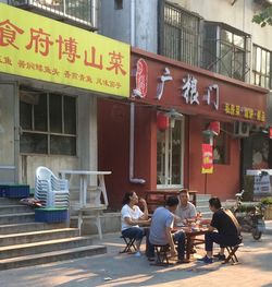 People at sidewalk cafe in city