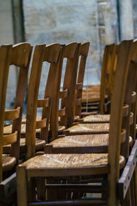 Empty chairs and tables in row