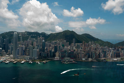 Panoramic view of sea and buildings against sky