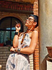 Full length of young woman sitting outdoors