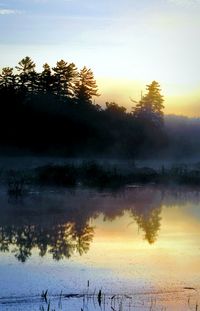 Scenic view of lake at sunset