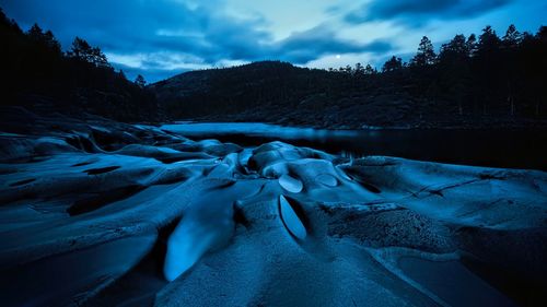 Frozen lake against sky during winter