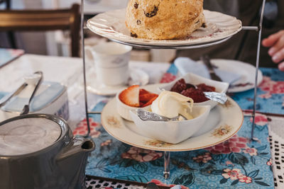 View from above of fruit scones, jam and cream, known as afternoon tea in uk.