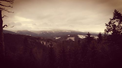 Scenic view of mountains against cloudy sky