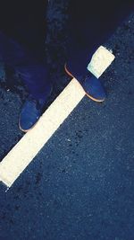 Low section of people standing on road