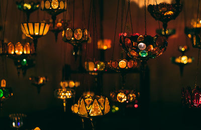 Illuminated lanterns hanging at store