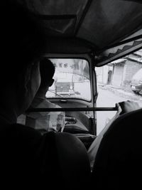 Rear view of woman sitting in train