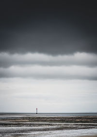 Scenic view of sea and lighthouse against sky