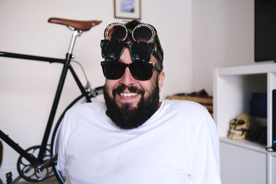 Happy man wearing sunglasses at home