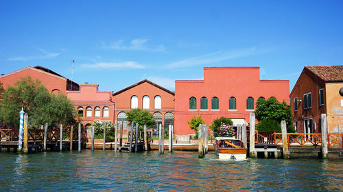 Building architecture, pier boats and canal in murano, venice, italy