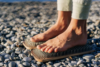 Close up of female feet on boards with nails.