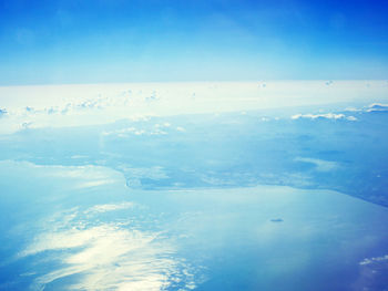 Aerial view of sea against blue sky