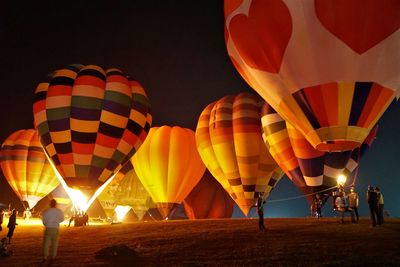 Hot air balloons on ground at night