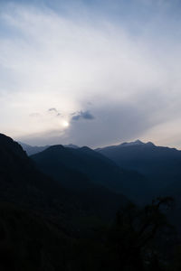 Scenic view of silhouette mountains against sky at dusk