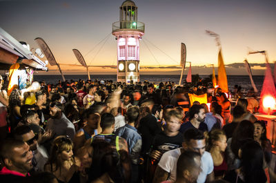 Crowd of people at festival during sunset