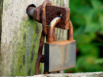 Close-up of padlock on rusty chain