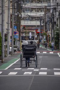 Vehicles on road against buildings in city