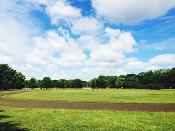 Scenic view of grassy landscape against cloudy sky