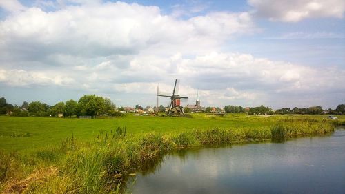 Scenic view of field against cloudy sky