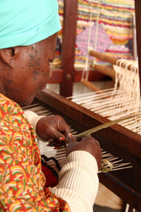 Woman working on loom at workshop
