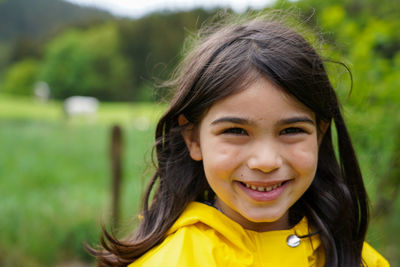 Portrait of a smiling girl standing outdoors