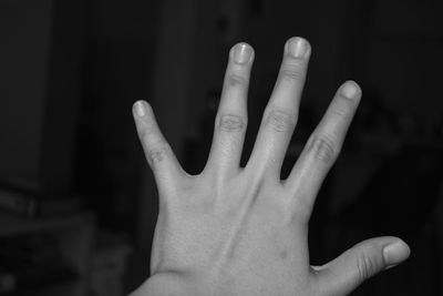 Close-up of human hand against black background