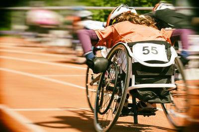 Rear view of people racing in wheelchairs