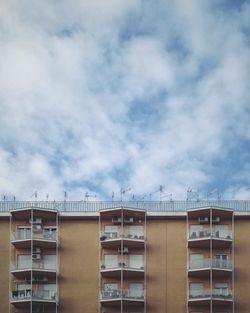 Low angle view of building against cloudy sky