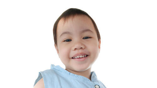 Portrait of smiling boy against white background