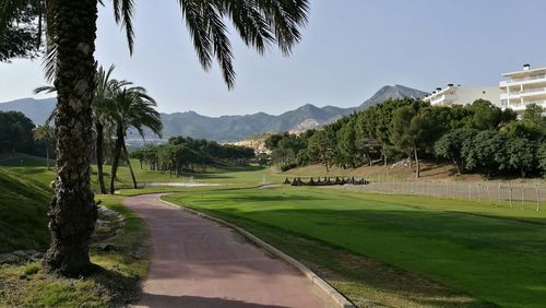 View of golf course against clear sky