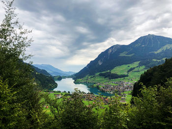 Scenic view of lake and mountains against sky