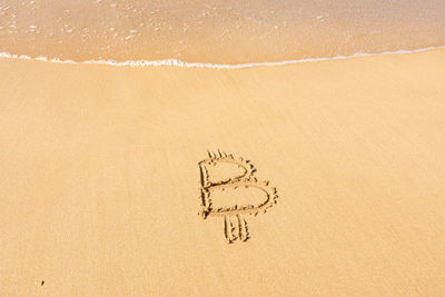 High angle view of text on sand at beach